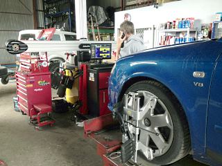 Wheel alignment equipment in use on a car at the workshop
